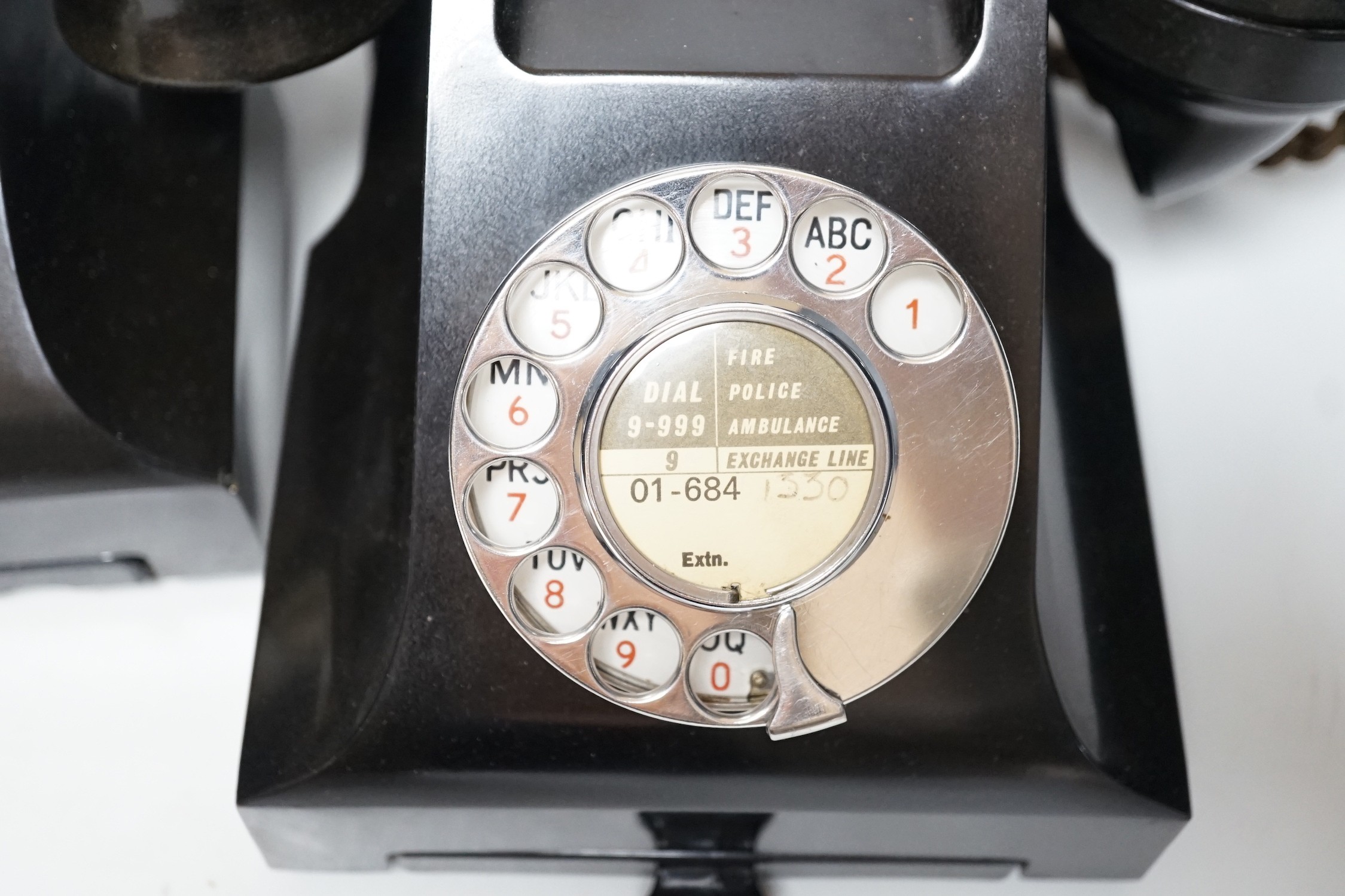 Two black Bakelite telephones with drawers